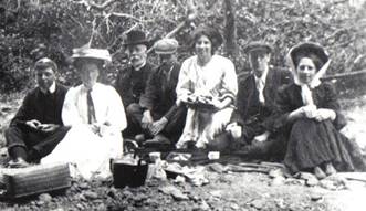 A vintage photo of a group of people posing for the camera

Description automatically generated