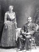 A vintage photo of a group of people posing for the camera

Description automatically generated