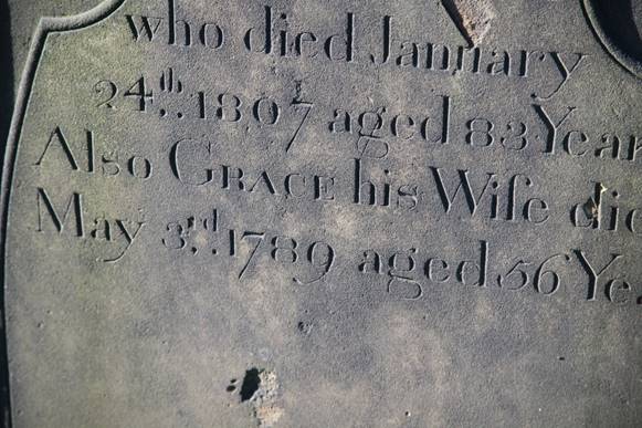 Close-up of a grave stone

Description automatically generated