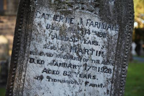 Close-up of a tombstone with a stone

Description automatically generated