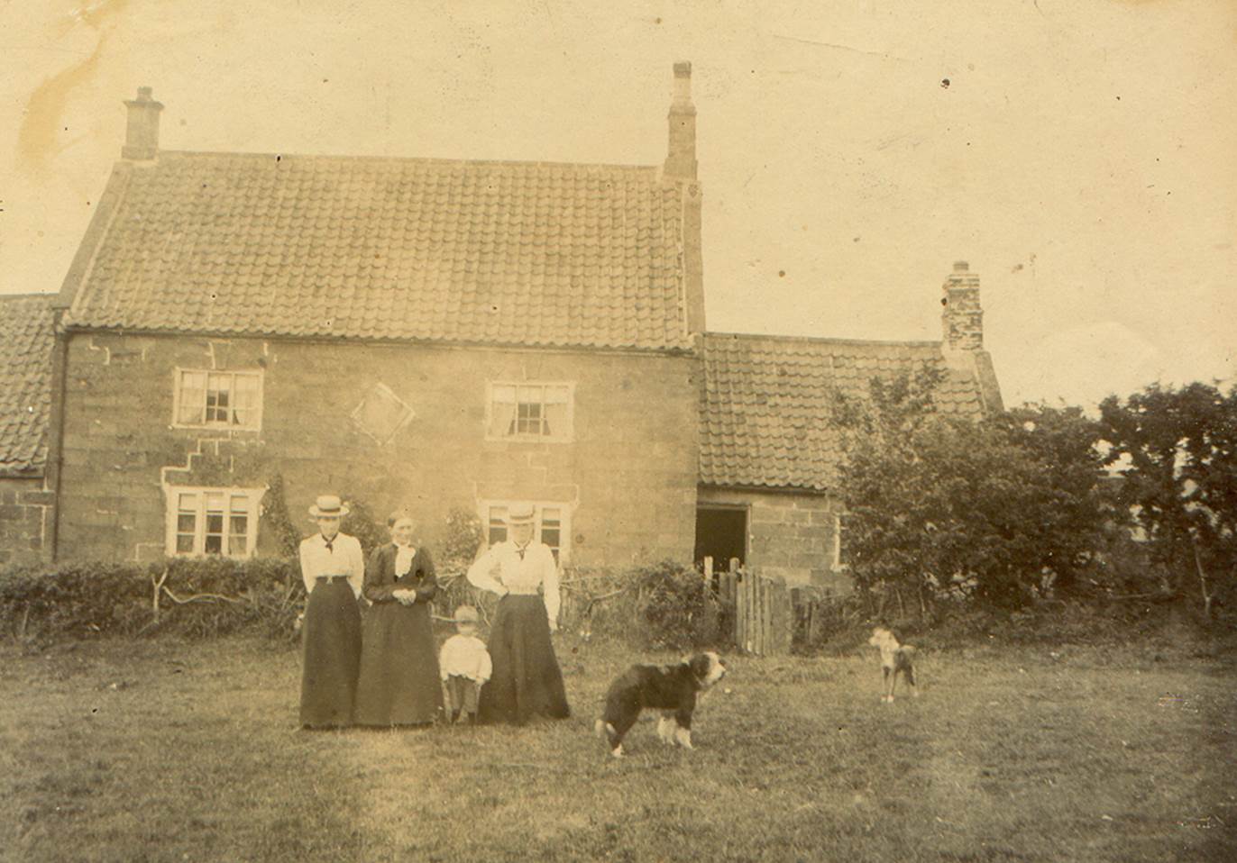 A family standing in front of a house

Description automatically generated