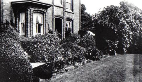 A black and white photo of a house and some trees

Description automatically generated with low confidence