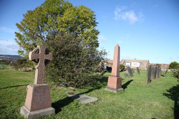 A cemetery with a cross on it

Description automatically generated with medium confidence