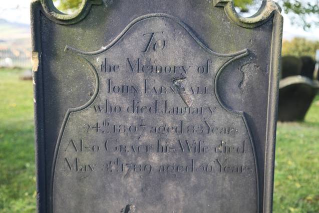 Close-up of a tombstone with a carved text

Description automatically generated