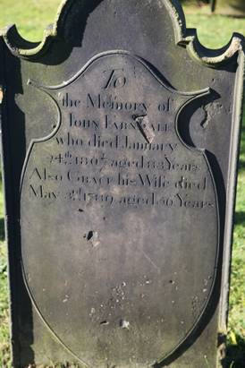 A tombstone with engraved text

Description automatically generated