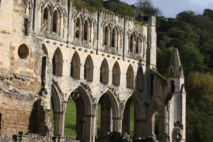 An old stone building with many arches

Description automatically generated