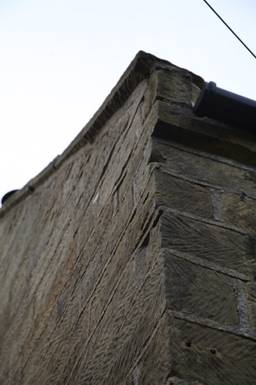A close-up of a stone corner

Description automatically generated