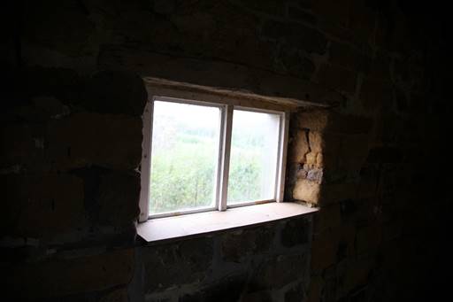 A window in a stone wall

Description automatically generated