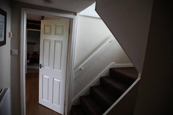 A staircase leading to a door

Description automatically generated