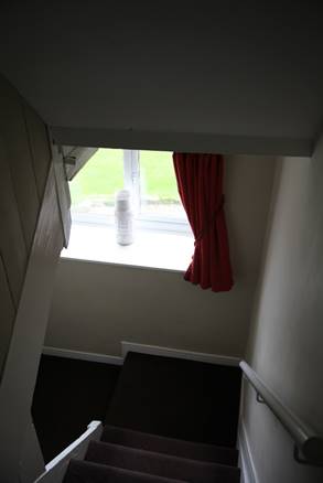 A red curtain on a window sill

Description automatically generated