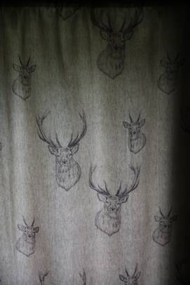 A grey fabric with drawings on it

Description automatically generated