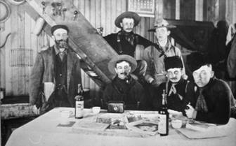 A group of men in cowboy clothing

Description automatically generated
