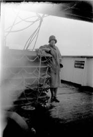A person standing on a deck of a ship

Description automatically generated