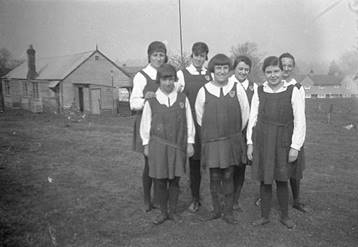 A group of young girls in uniform

Description automatically generated