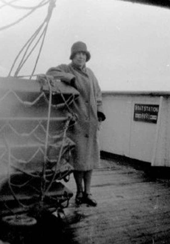 A person standing on a deck of a ship

Description automatically generated