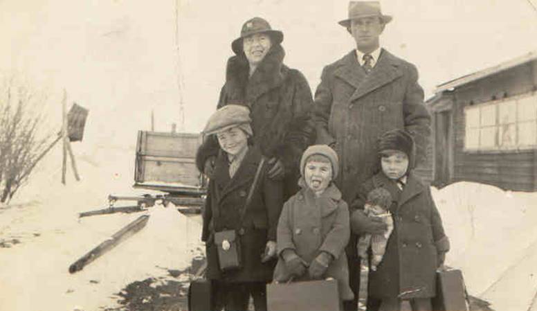 A family posing for a photo in the snow

Description automatically generated