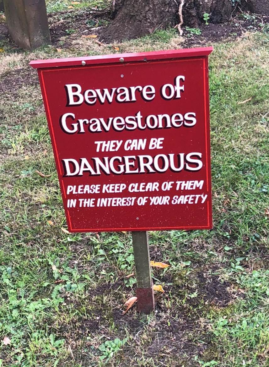 A sign in front of a tree
Description automatically generated