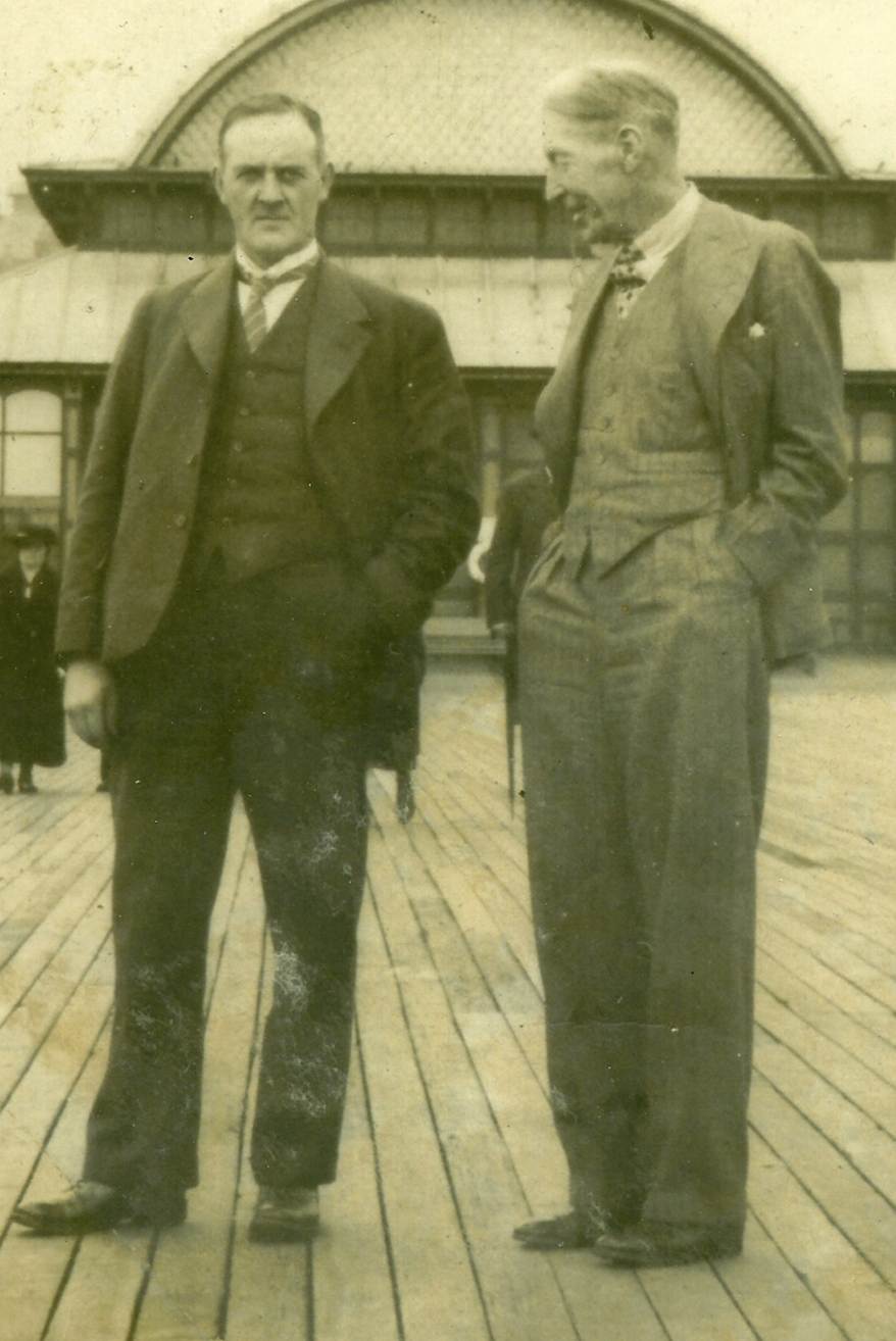 A couple of men standing on a deck
AI-generated content may be incorrect.