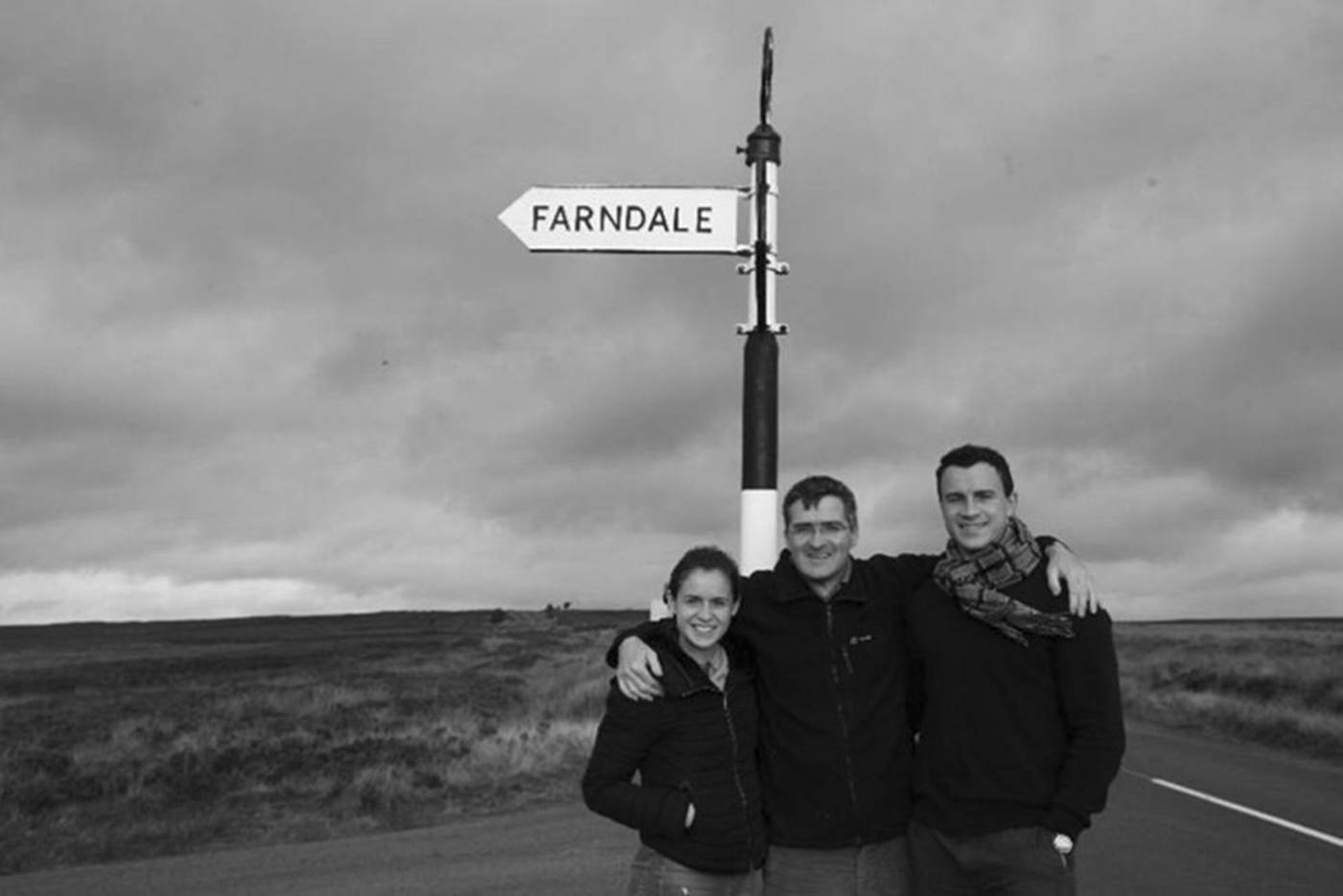 A group of people standing in front of a sign

AI-generated content may be incorrect.