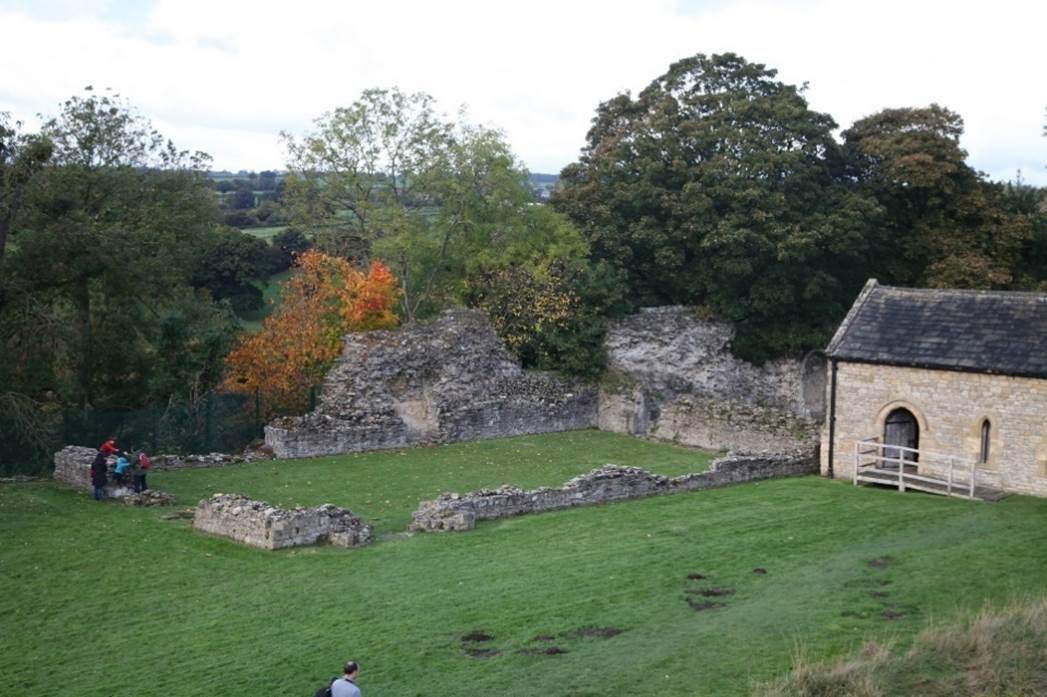 A stone building and grass field

Description automatically generated with medium confidence