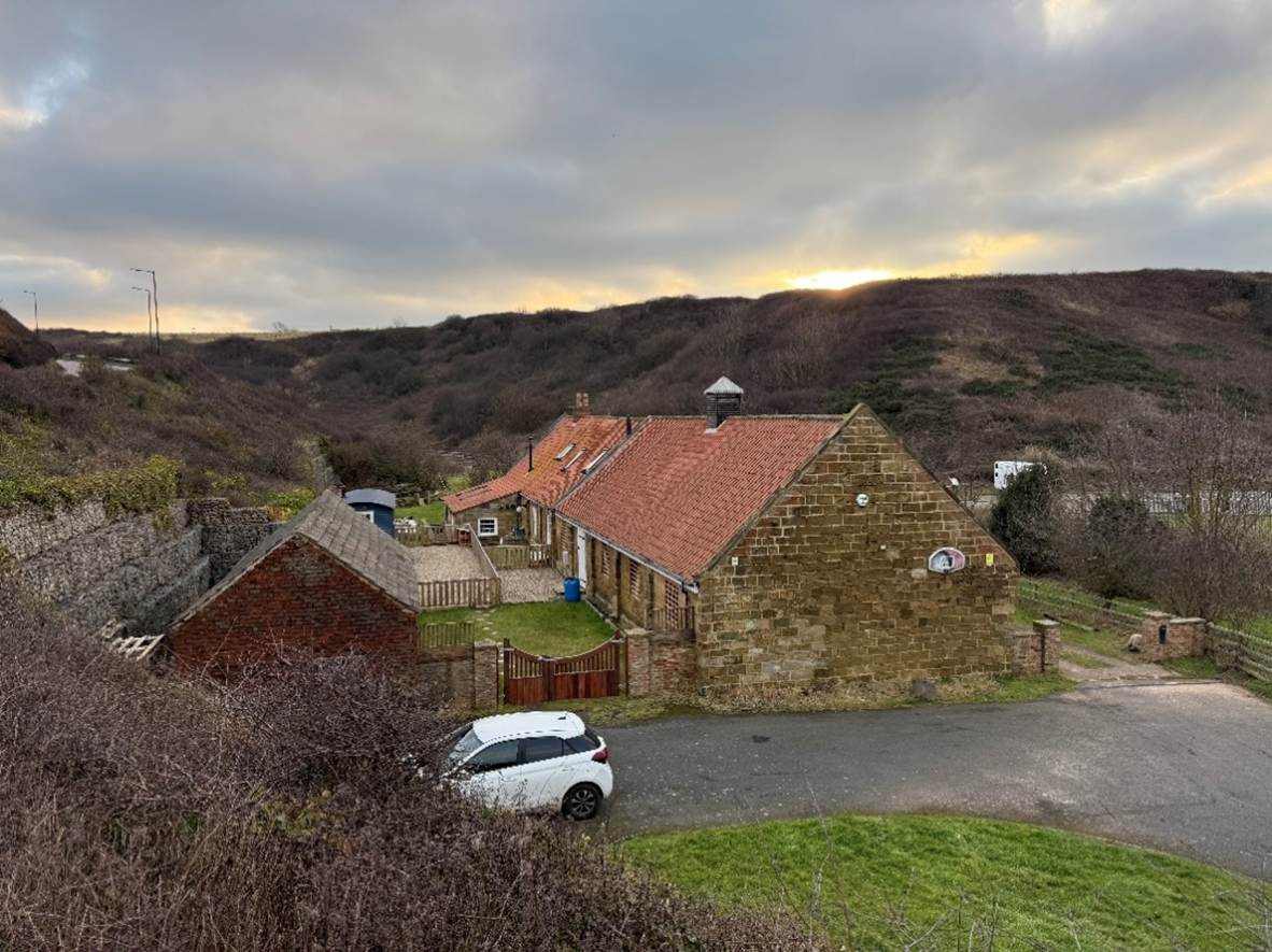 A house with a car parked in front of it

AI-generated content may be incorrect.