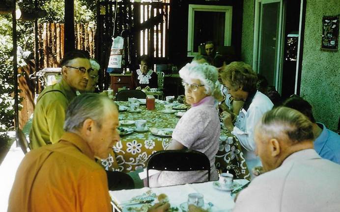 A group of people sitting at a table
Description automatically generated