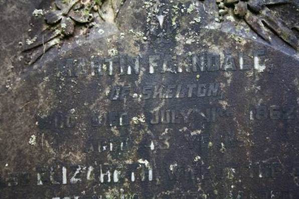 Close-up of a tombstone with engraved text

Description automatically generated