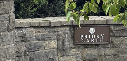 A sign on a stone wall

AI-generated content may be incorrect.
