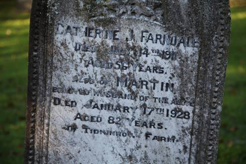 Close-up of a tombstone with text

Description automatically generated