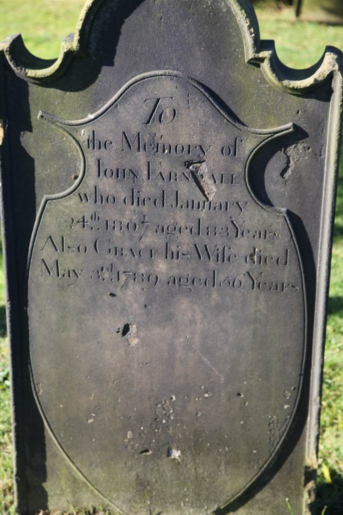 A tombstone with engraved text

Description automatically generated