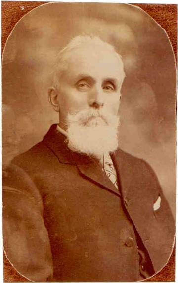 A person with a white beard
Description automatically generated