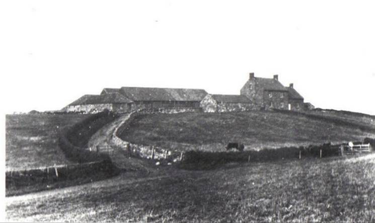 A black and white photo of a house on a hill
Description automatically generated with medium confidence