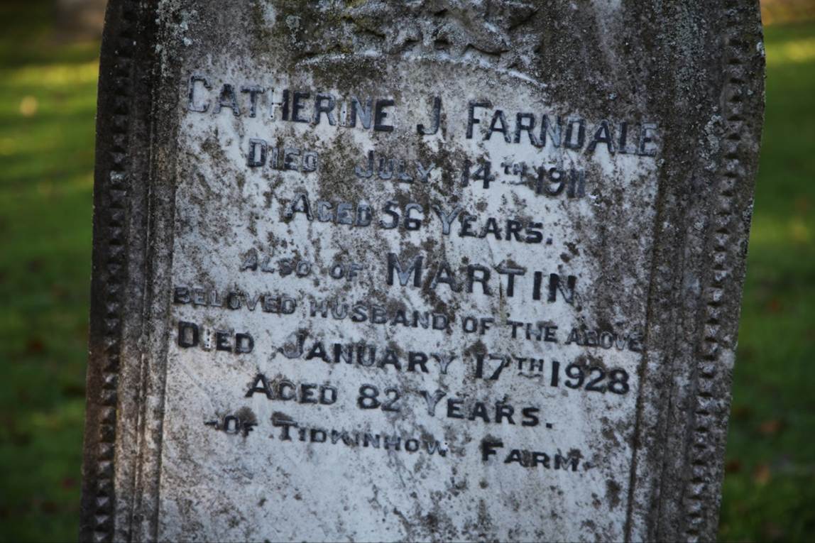 Close-up of a tombstone with a text
Description automatically generated