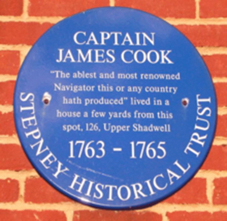 A blue sign on a brick wall

Description automatically generated