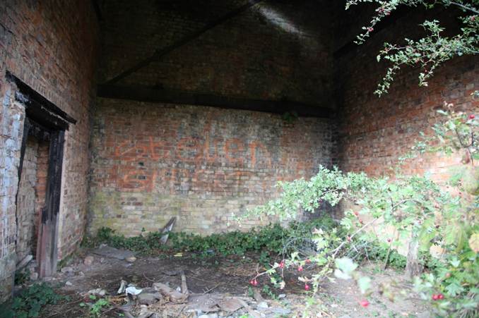 A brick wall with graffiti on it
Description automatically generated