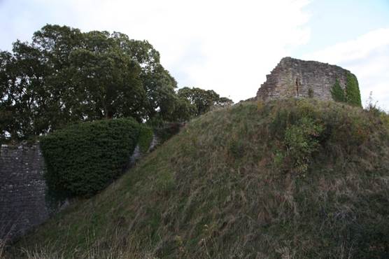 A stone building on a hill

Description automatically generated