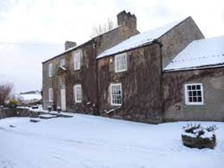 A house with snow on the ground
Description automatically generated
