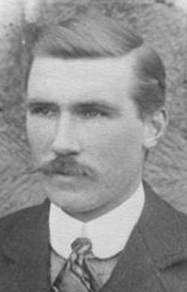 A person wearing a suit and tie

Description automatically generated