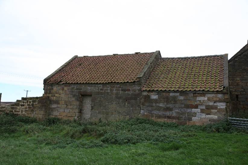 A stone church with a cemetery

Description automatically generated