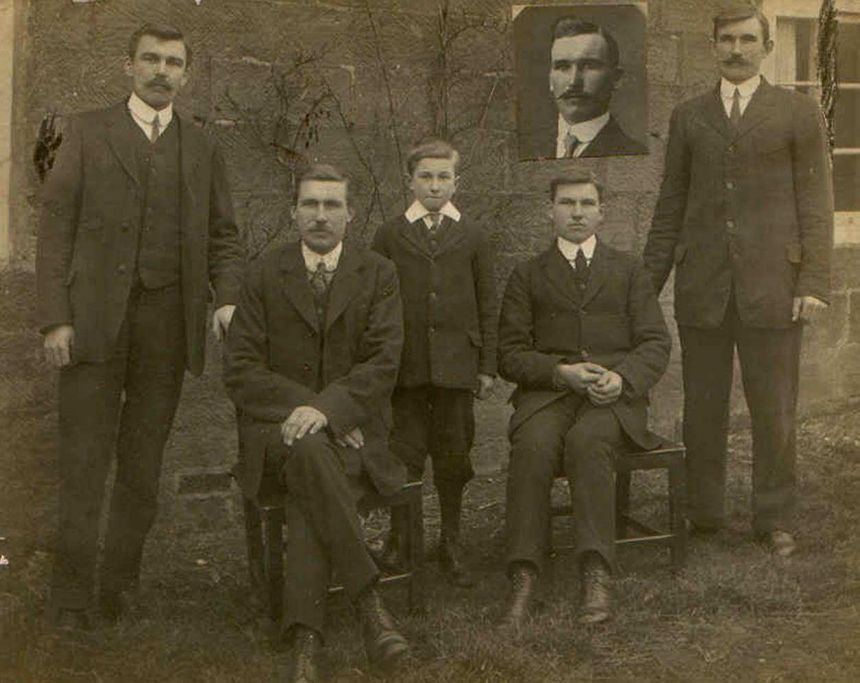 A group of men posing for a photo

Description automatically generated